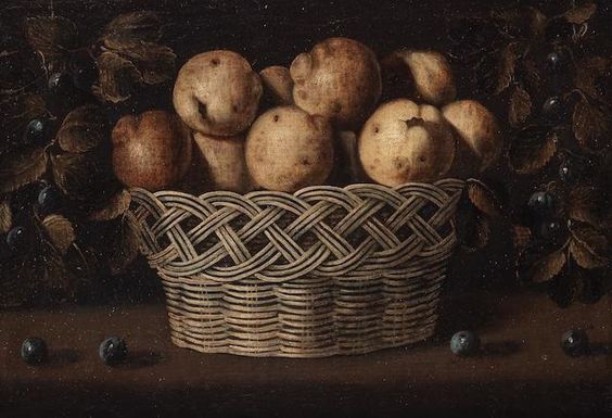 A still life with a basket of quinces on a wooden table and damsons hanging from strings on either side - Juan van der Hamen y León